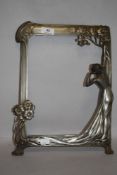 An Art Nouveau picture or mirror frame in an Archibald Knox Liberty style with female figure and