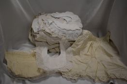 A mixed lot of antique children's clothing including embroidered bibs and dresses, also included are