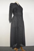 A semi sheer navy blue Art deco day dress having side metal zip, long sleeves and V neckline, larger