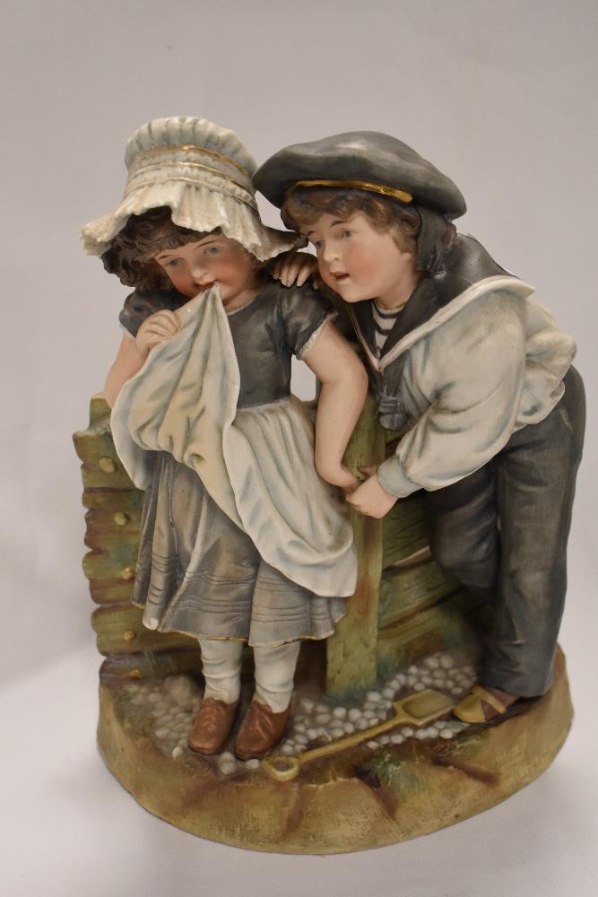 A large early 20th century German bisque figure base of two children dressed as sailors. damage to