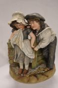 A large early 20th century German bisque figure base of two children dressed as sailors. damage to