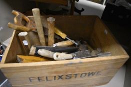 A vintage wooden Port crate containing a selection of builders and DIY tools
