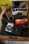 A box of camera filters, light meters, lenses and covertors