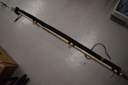 A vintage fiberglass beachcaster rod and a Steade fast spinning rod