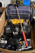 A box of filters, flashes and tripods with a camera bag