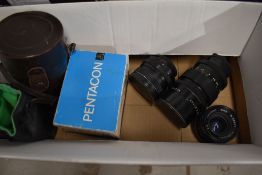 Three camera lenses including a Pentacon Auto 2.8/29, Pentacon 2.8/135 and a Paragon 1.35.