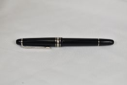 A Montblanc Meisterstuck 144 converter fountain pen in black with platinum plated trim having a