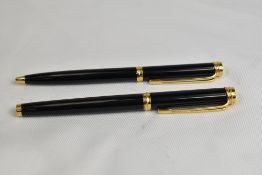 A Waterman CF Converter fill fountain pen and Ballpoint pen set in black with gold trim having