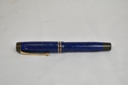 A Parker Duofold Streamlined Jr button fill fountain pen in lapis blue with two bands to the cap