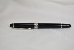 A Montblanc Meisterstuck 144 converter fountain pen in black with platinum plated trim having a