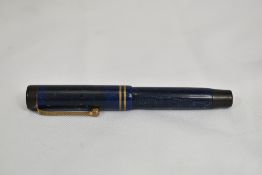 A Parker Duofold Jr button fill fountain pen in lapis blue with two bands to the cap having Parker