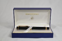 A boxed Waterman Liason converter fill fountain pen in black with gold trim having Waterman gold