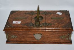 An Edwardian smokers table box, having brass mounts, carrying handle and two internal compartments.