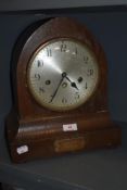 A 1920s oak chiming mantel clock, having plaque to foot reading 'Presented to Mr W H Green, by his