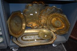 Five vintage Middle Eastern brass trays, having intricate embossed scenes, including elephants, some