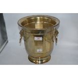 A vintage plated champagne bucket, having lion mask and hooped handles.