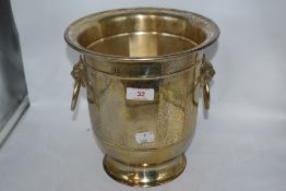 A vintage plated champagne bucket, having lion mask and hooped handles.
