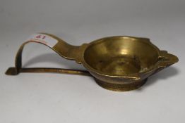A primitive 19th century brass animal fat lamp.