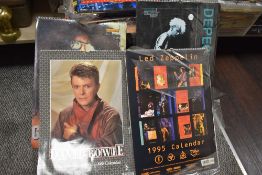A collection of collectable calendars, including 1980s and 90s band interest such as Dire Straits,