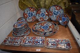 A collection of 20th century graduated Chinese plates, having red and blue transfer pattern with