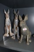 Three composite hare studies and a rabbit door stop.