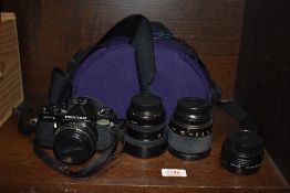 An Asahi Pentax MVI camera with Pentax-M 1:2,8 40mm lens, Tokina SD 28-70mm 1:3,5-4,5 lens, and