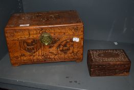 A mid century Chinese carved camphor wood box, sold along side another smaller carved trinket box.