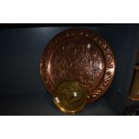 A large Keswick school of industrial arts copper charger with floral embossed design and scroll