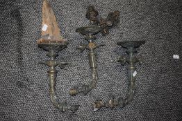 Three antique moulded brass wall mounted gas lamps.
