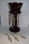 A Victorian ruby glass table lustre, with gilt heightening (worn) having five clear glass drops.