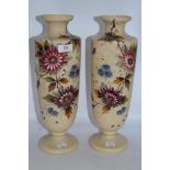 A pair of Victorian milk glass vases, having hand painted floral designs and accented with gilt,