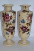 A pair of Victorian milk glass vases, having hand painted floral designs and accented with gilt,
