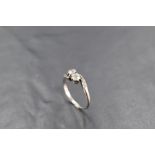 A two stone diamond ring, total approx 0.5ct to diamond chip set crossover shoulders on a white
