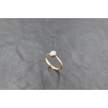 An 18ct gold and platinum set single-stone opal ring, the small oval opal within a beaded setting,
