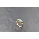 An 18ct gold turquoise and diamond ring, having oval turquoise cabochons interspersed by small