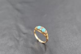 An 18ct gold turquoise and diamond ring, having oval turquoise cabochons interspersed by small