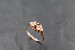 A garnet and seed pearl ring on a rose gold loop stamped 10K, size N & approx 2.7g