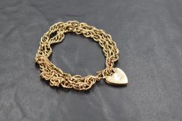 A 9ct gold double-strand bracelet with heart-shaped padlock clasp, marked 375 to clasp, 27grams