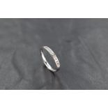 A ten stone channel set diamond chip eternity ring on an 18ct white gold loop, size L & approx 2.1g