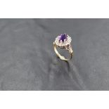 A heat treated amethyst and diamond chip cluster ring in illusionary setting to open shoulders on