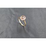 An 18ct gold andalusite and diamond cluster ring, the central raised oval-cut stone within a