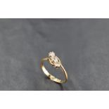 A diamond trilogy ring, total approx 0.35ct having crossover shoulders on a yellow metal loop, marks