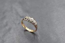 A five stone graduated old cut diamond ring, total approx 0.5ct in an open gallery mount on a yellow