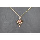 An Edwardian 9ct gold, pink stone and seed pearl pendant, having central oval-cut pink stone