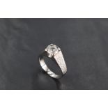 A 1970's diamond solitaire ring, approx 1.5ct in a four claw mount with brushed raised shoulders