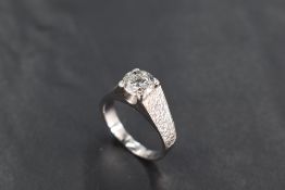 A 1970's diamond solitaire ring, approx 1.5ct in a four claw mount with brushed raised shoulders