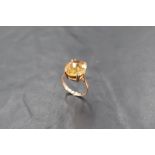 A 9ct gold and citrine dress ring, the oval-cut stone claw set to the plain shank, marked 375,