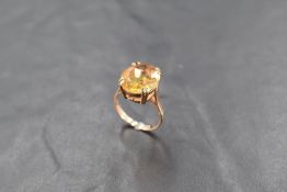 A 9ct gold and citrine dress ring, the oval-cut stone claw set to the plain shank, marked 375,