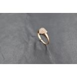 A diamond cluster ring in the form of a heart on a 9ct gold loop, size P & approx 2.5g