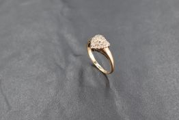 A diamond cluster ring in the form of a heart on a 9ct gold loop, size P & approx 2.5g